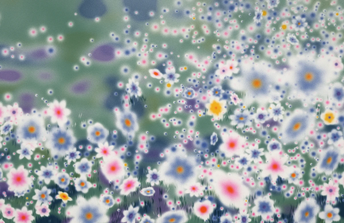 A soft-focus green meadow crowded with white, blue and pink blossoms with violet and orange centers.